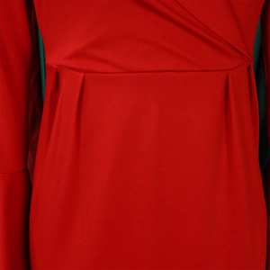Detailed macro view of the red V-neck dress featuring elegant waist pleats and stitching
