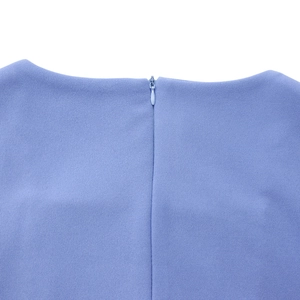 Detail of invisible zipper closure on light blue square neck dress with textured fabric