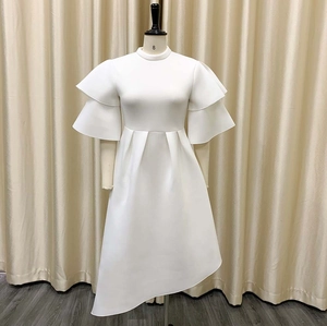 Detailed view of layered ruffle sleeves and high neckline on a white evening dress