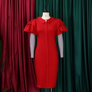 Detail of red dress with Peter Pan collar, pearl button, and dotted mesh sleeves