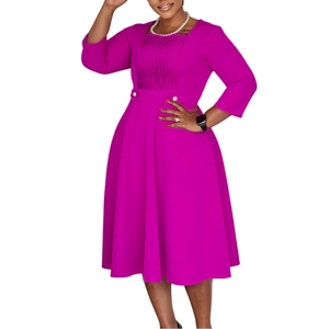 Detail of fuchsia square neck dress featuring vertical pleats and high waist buttons