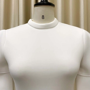 Detail of high round neckline and premium stretch knit fabric on a slim white evening dress
