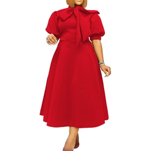 Detail view of red midi dress featuring an oversized bow tie neck and puff sleeves