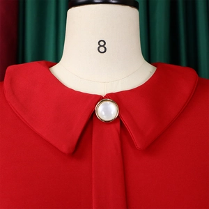 Close-up of red mesh dress with Peter Pan collar and white pearl button detail