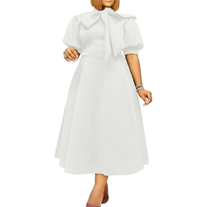 Detailed front view of white dress featuring elegant bow collar and puff sleeves