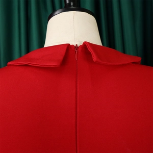 Detail of red dress showing the invisible back zipper and elegant round collar