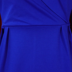 Detail of royal blue v-neck dress featuring knit texture and elegant waist pleats