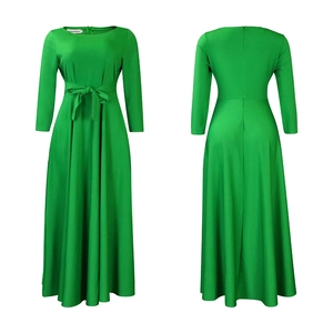 Detail of green long-sleeve maxi dress showing high waist tie and elegant A-line silhouette