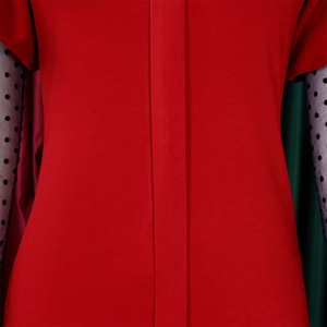 Detail of red pleated fabric with vertical placket and black polka dot mesh sleeves