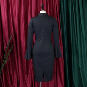 Detail of the back slit and flared sleeves on this elegant black V-neck fitted dress
