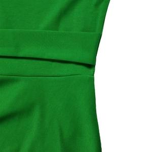 Macro detail of high-quality green fabric texture and waist stitching on the dress