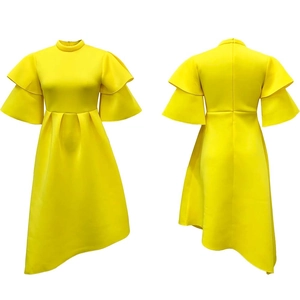 Detail of a bright yellow dress with double ruffle sleeves and asymmetric hemline