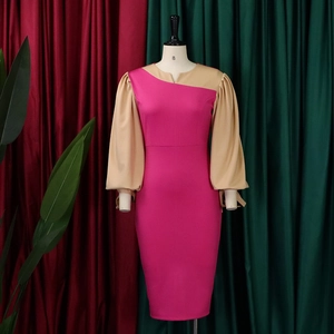 Detail of lantern sleeves and asymmetric collar on a pink and khaki color block dress