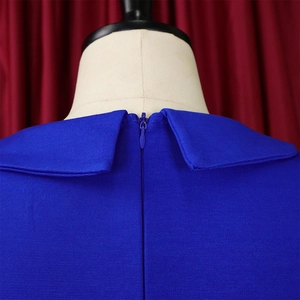 Detail of royal blue dress with Peter Pan collar and hidden back zipper on a mannequin