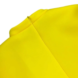 Detail of invisible back zipper closure on the bright yellow formal evening dress
