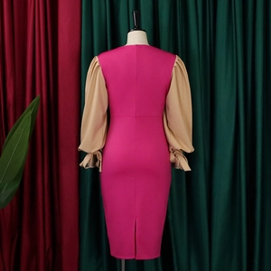 Detail of fuchsia bodycon dress featuring lantern sleeves with bow-tie cuff accents