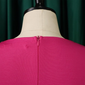 Close-up of invisible rear zipper on a magenta dress with detailed fabric texture