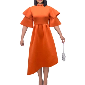 Close-up of vibrant orange dress with double ruffle sleeves and asymmetric hem detail