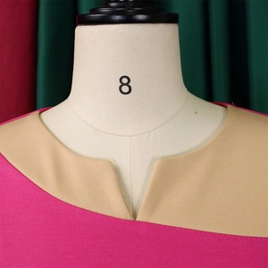 Detail of V-notch neckline and pink and khaki patchwork on the knit dress fabric