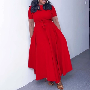Detail of red short sleeve maxi dress with waist tie and flowing flared skirt design