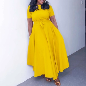 Detailed view of bright yellow maxi dress with waist tie and flowing irregular hemline