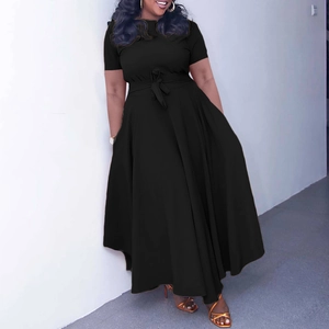 Detail of plus size black maxi dress with waist tie and fluid draped skirt fabric