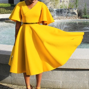 Close-up of elegant V-neck dress with flare sleeves and large flowing skirt hem