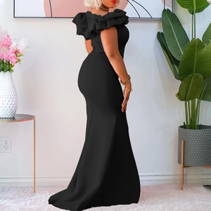 Detail of off-shoulder ruffled neckline and sleek fishtail silhouette on a black evening gown