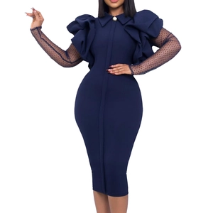 Detail of navy slim dress featuring ruffled shoulders and black mesh polka dot sleeves