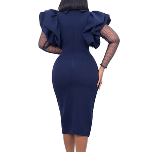 Detail of navy bodycon dress showing layered ruffle cuffs and black polka dot mesh sleeves