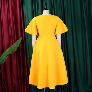 Back view of yellow A-line dress featuring elegant flare sleeves and wide flowy skirt