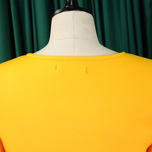 Detailed close-up of the V-neckline and fabric texture on a yellow flare sleeve dress