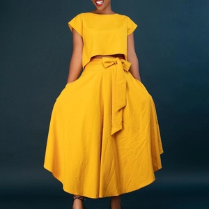 Elegant plus size women's two-piece set featuring yellow crop top and high waist A-line skirt