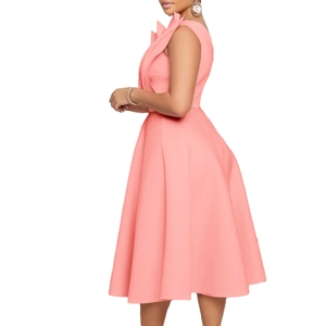 Close-up of sculptural ruffle detail and waistline on a pink evening cocktail dress