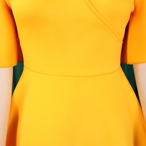 Detail of cross V-neck and high waist seam on a bright yellow flare sleeve dress