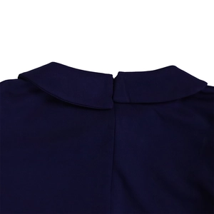Detail of navy blue dress featuring a neat Peter Pan collar and smooth fabric texture
