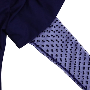 Detail of navy blue knit fabric with sheer black polka dot mesh sleeve stitching