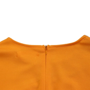 Detail shot of invisible zipper closure on the back of an orange round-neck dress