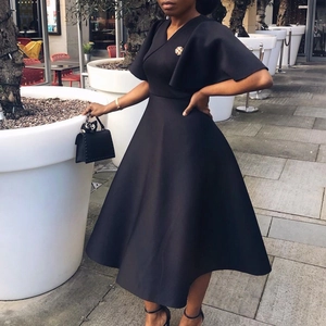 Detail showing the deep V-neck and elegant flare sleeves of this black A-line dress