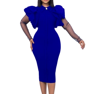 Detail of royal blue fitted dress featuring 3D ruffles and black mesh polka dot sleeves