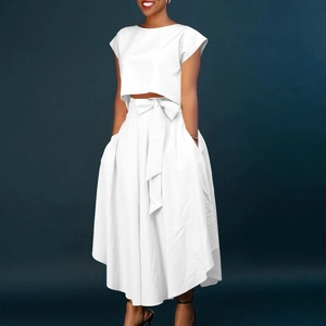 White two-piece set featuring a cropped short-sleeve top and high-waist maxi skirt with bow