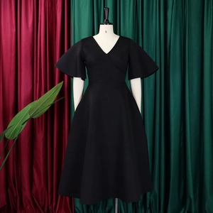 Detailed view of black V-neck dress with flare sleeves and elegant A-line flared hemline