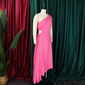 Detail of pink one-shoulder dress featuring waist hollow-out and asymmetrical hemline