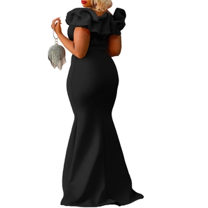 Detailed view of ruffled off-shoulder neckline and sleek mermaid silhouette of black dress