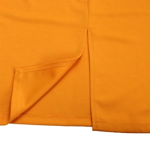 Detailed close-up of high-quality stitching and split hem design on orange dress