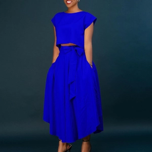 Detail of high-waist maxi skirt with waist-tie bow and matching crop top in navy blue