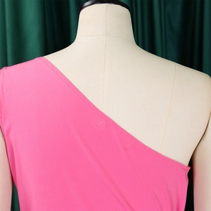 Detail shot of a pink one-shoulder dress showing smooth fabric and stitching on a mannequin