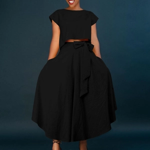 Detail of high-waist maxi skirt featuring a waist tie bow and hidden side pockets