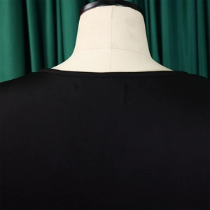 Close-up of the round neckline and stitching details on a black evening gown