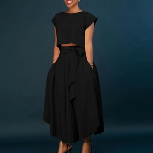 Detail of high waist maxi skirt with bow tie belt and side pockets in black set